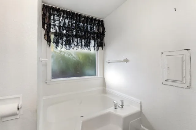 a backyard of a house with table and chairs