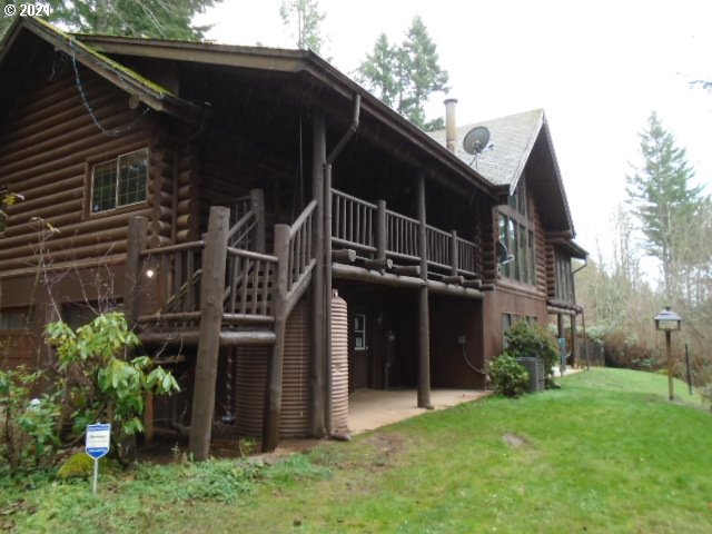 12125 Southeast Laughing Water Road Sandy, OR 97055 - Photo 1 of 24 a view of a house with a yard and plants