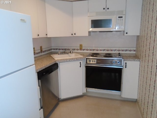 12125 Southeast Laughing Water Road Sandy, OR 97055 - Photo 16 of 24 a kitchen with a stove and a microwave