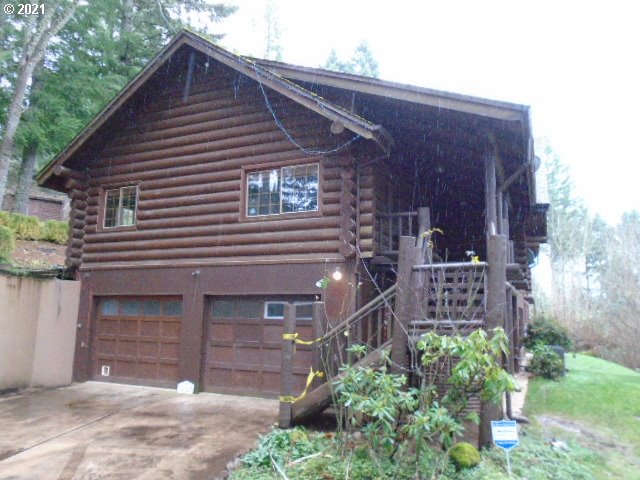12125 Southeast Laughing Water Road Sandy, OR 97055 - Photo 2 of 24 a front view of a house with garden