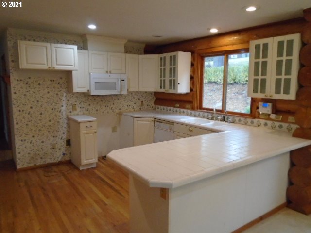 12125 Southeast Laughing Water Road Sandy, OR 97055 - Photo 6 of 24 a kitchen with stainless steel appliances granite countertop a sink a stove and a refrigerator