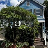 a front view of a house with a garden