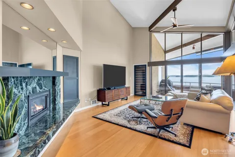 a living room with furniture and a floor to ceiling window