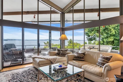 a dining room with furniture water view and wooden floor