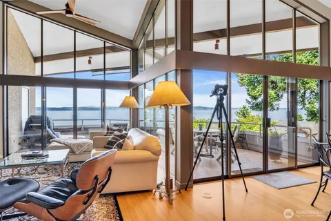 a dining room filled chandelier and wooden floor