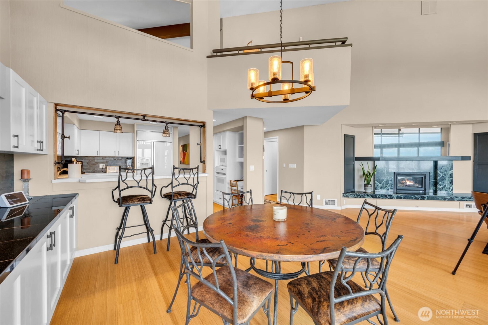 7019 47th Avenue Southwest, Unit 18 Seattle, WA 98136 - Photo 17 of 39 a dining room filled chandelier and wooden floor