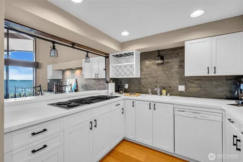 a kitchen with cabinets oven and white appliances