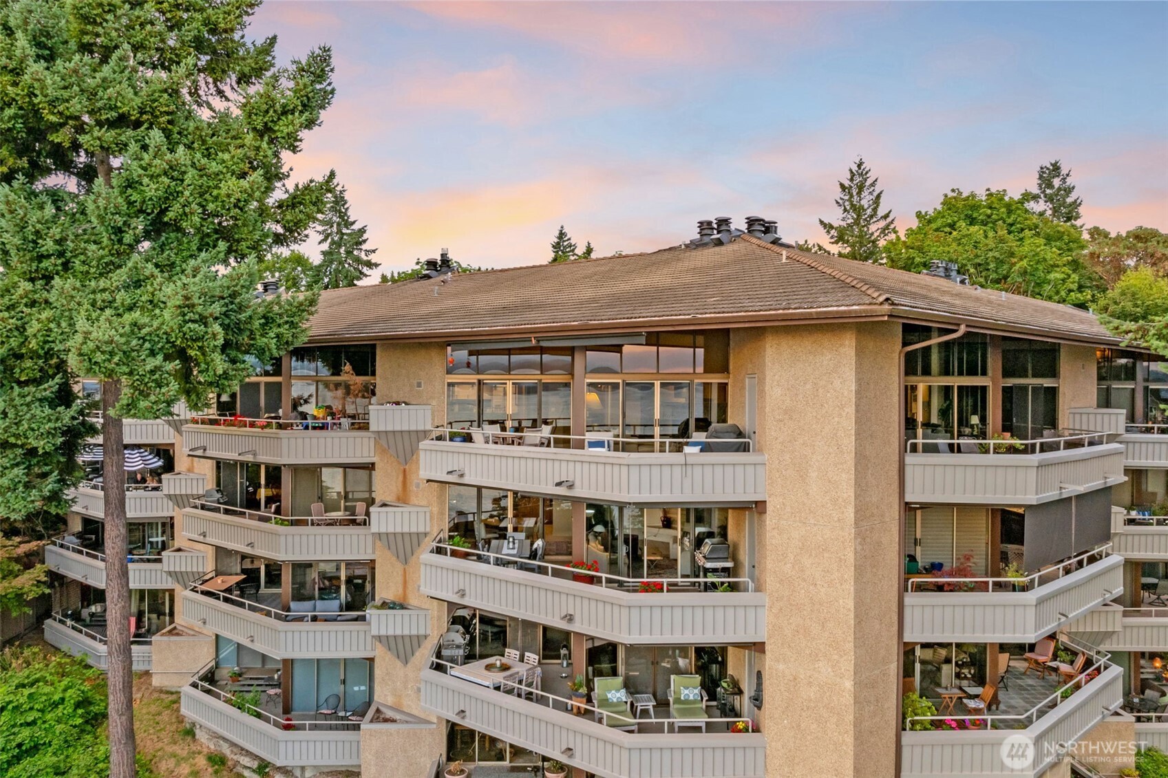 7019 47th Avenue Southwest, Unit 18 Seattle, WA 98136 - Photo 3 of 39 a front view of a residential apartment building with a yard