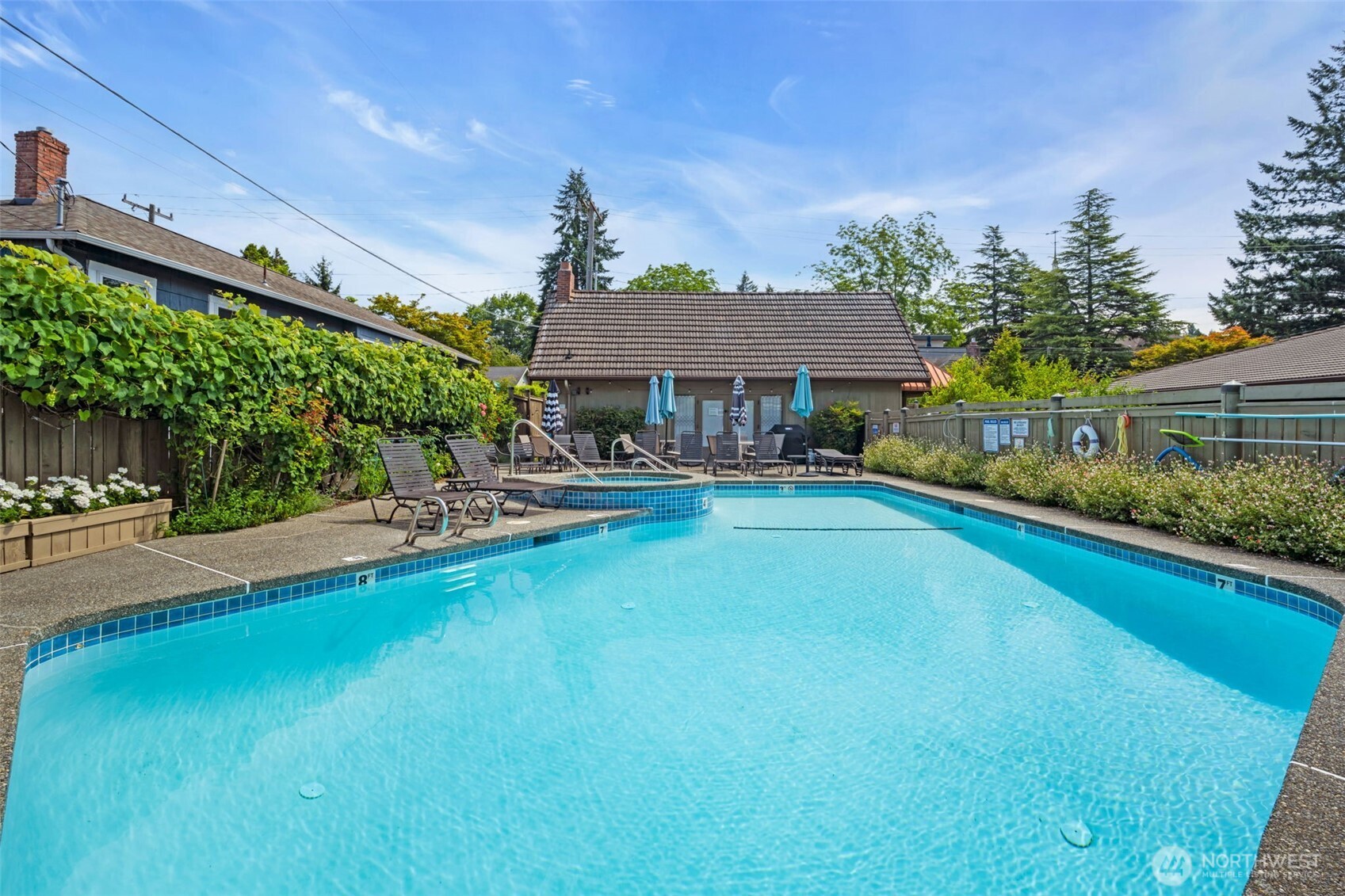 7019 47th Avenue Southwest, Unit 18 Seattle, WA 98136 - Photo 35 of 39 a house view with swimming pool and garden space