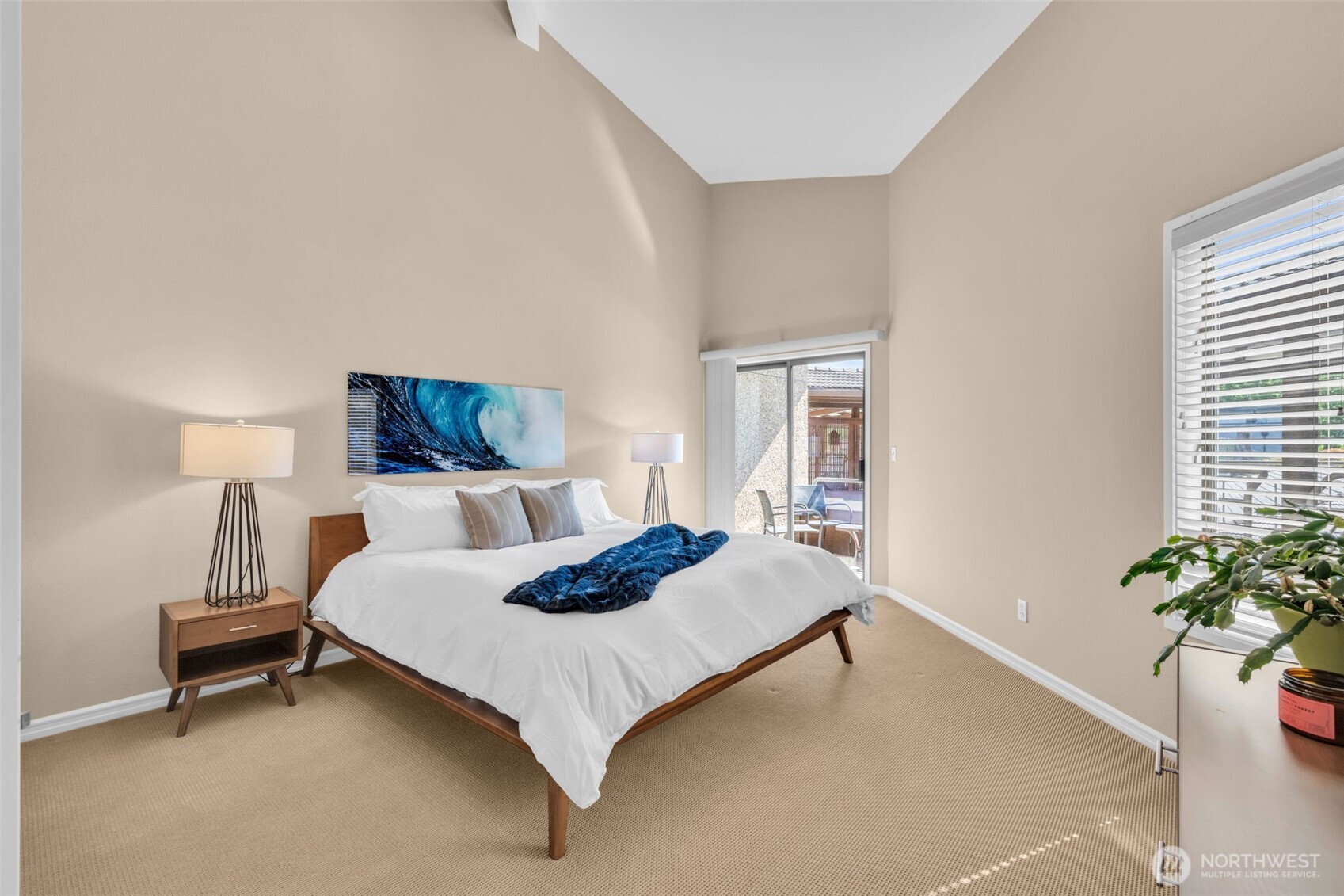 7019 47th Avenue Southwest, Unit 18 Seattle, WA 98136 - Photo 7 of 39 a bedroom with a bed and a potted plant