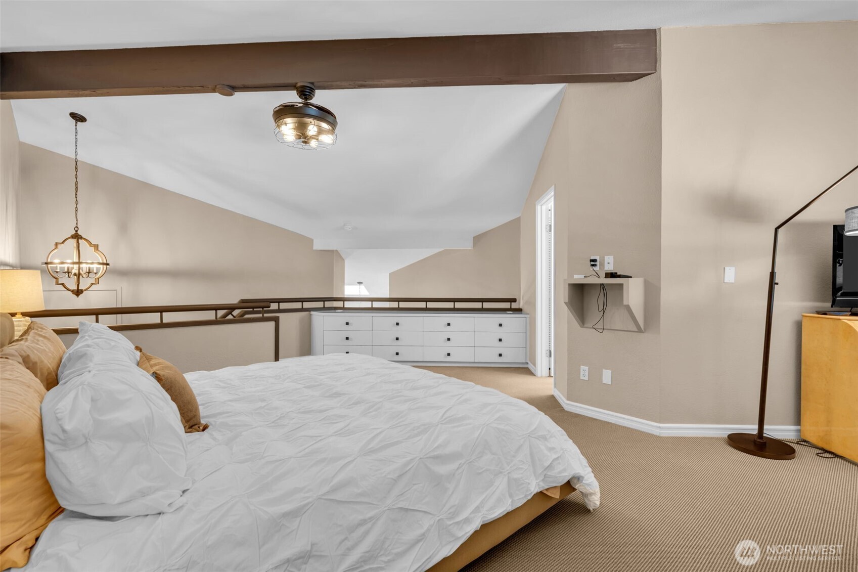 7019 47th Avenue Southwest, Unit 18 Seattle, WA 98136 - Photo 10 of 39 a spacious bedroom with a bed and a flat screen tv