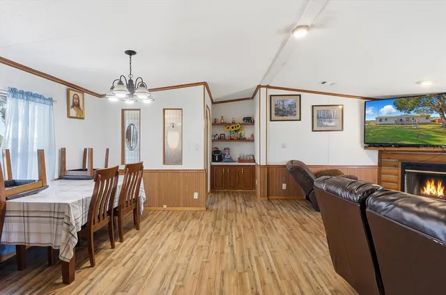 a living room with fireplace furniture and a flat screen tv