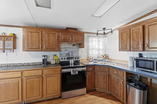 a kitchen with a sink stove and cabinets