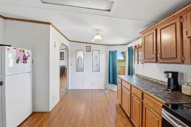 a kitchen with stainless steel appliances granite countertop a refrigerator and a sink