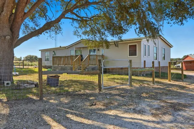 a view of a house with backyard porch and sitting area
