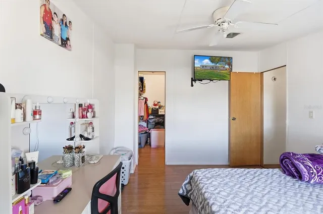 a bedroom with a bed and wooden floor
