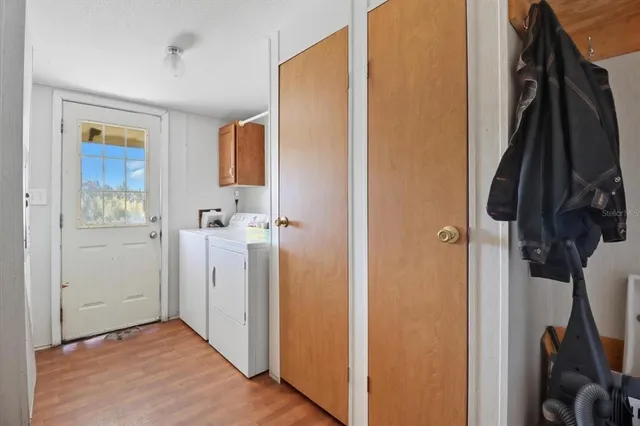 a view of walk in closet with clothes