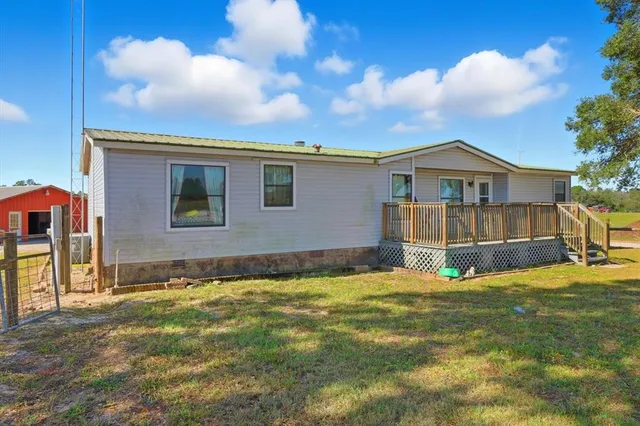 a view of an house with backyard and a garden