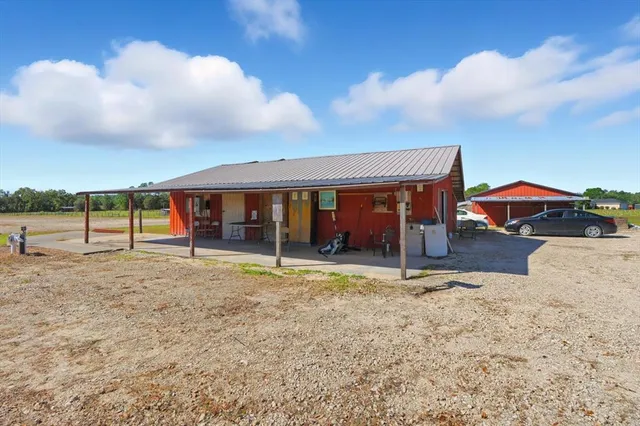 a view of house with outdoor space and wooden fence