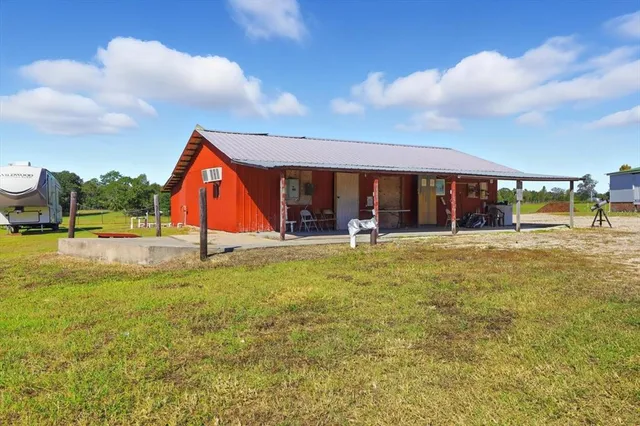 a view of swimming pool with lawn chairs and a big yard