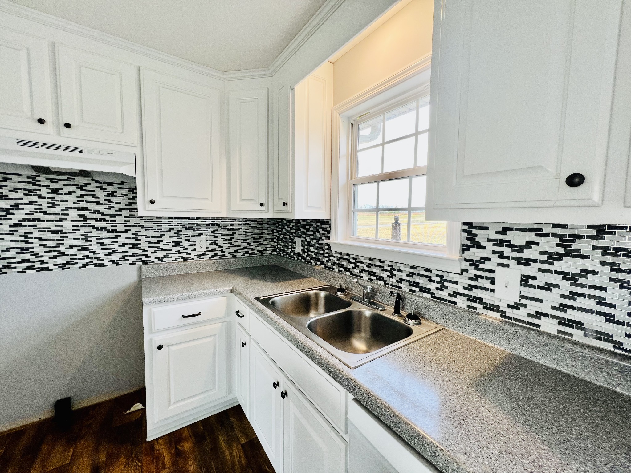 640 Howell Hill Road Flintville, TN 37335 - Photo 3 of 18 a kitchen with granite countertop a sink and a stove