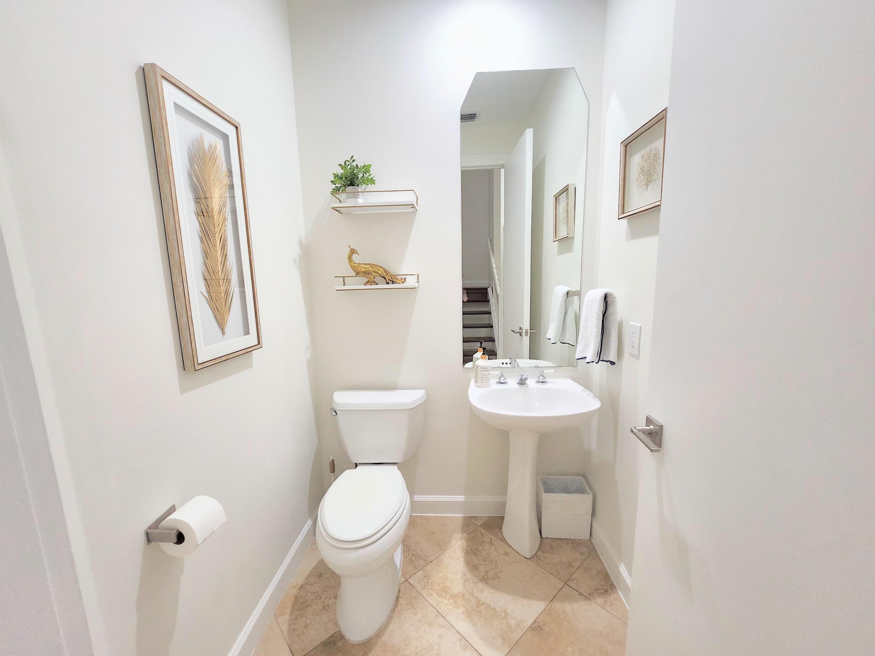 3567 Commodore Circle Delray Beach, FL 33483 - Photo 35 of 76 a bathroom with a toilet sink and mirror