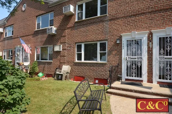 a front view of a house with outdoor seating