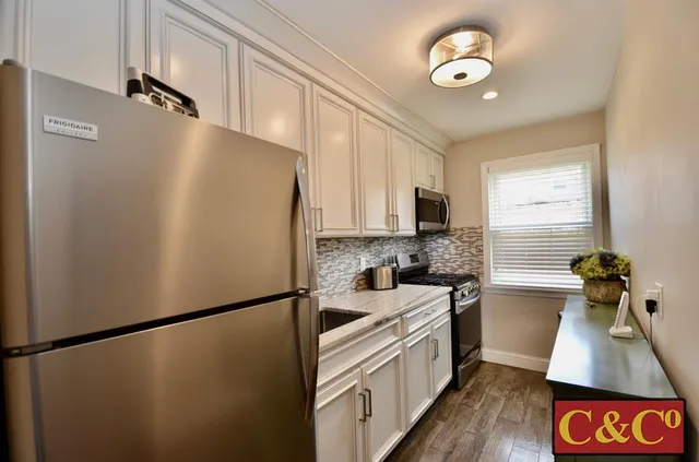 a kitchen with a refrigerator and a sink