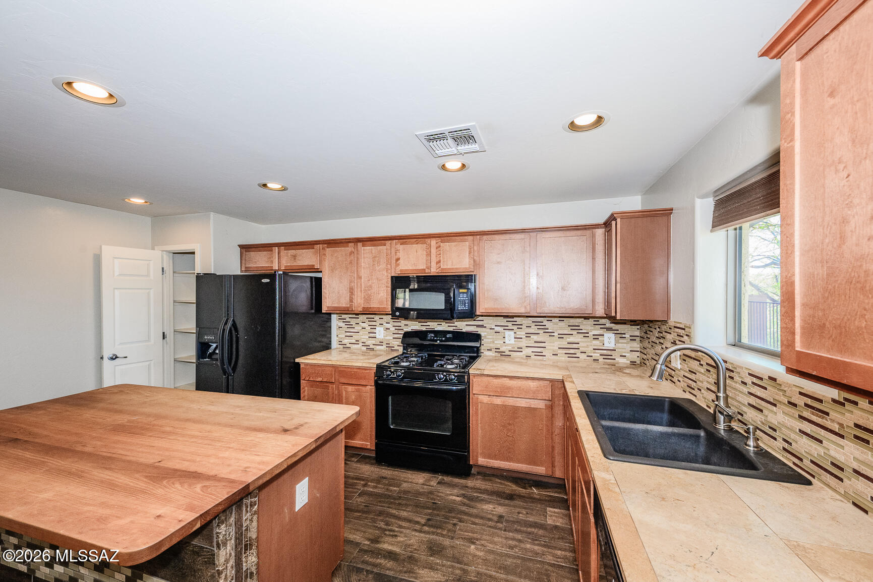 728 South Porter Routh Place Vail, AZ 85641 - Photo 9 of 36 a kitchen with stainless steel appliances kitchen island granite countertop a refrigerator stove top oven and sink