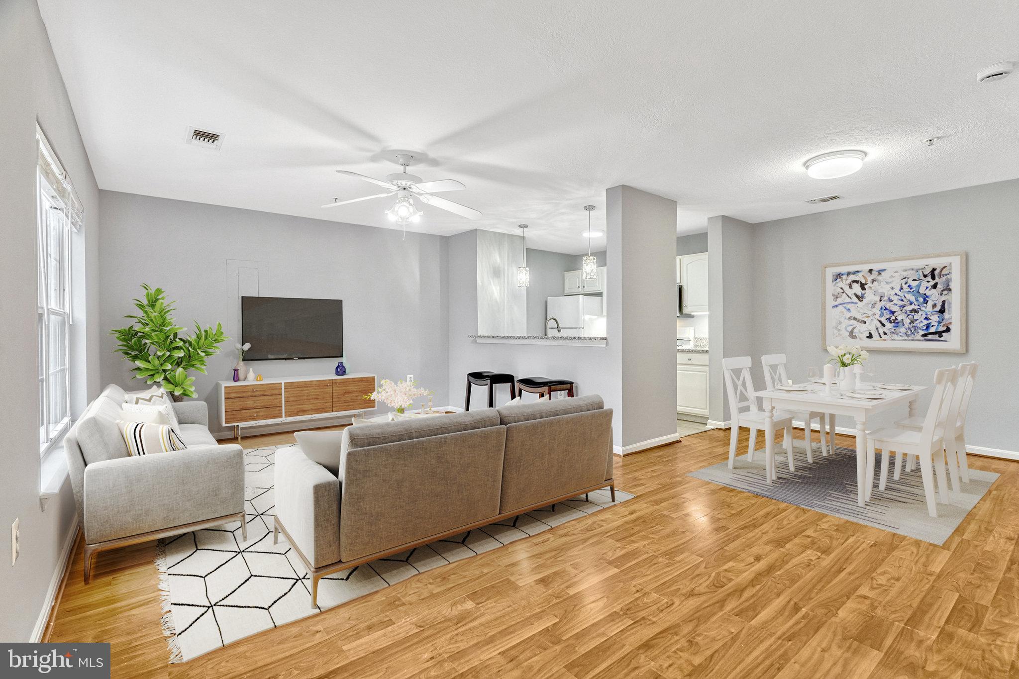 a living room with furniture a flat screen tv and a dining table