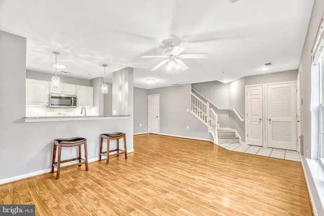 a view of a kitchen with dining room and wooden floor
