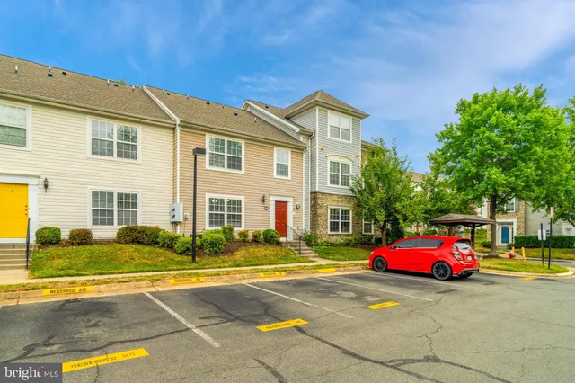 a front view of a house with cars parked