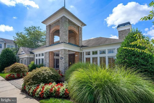 a front view of house with yard and trees around
