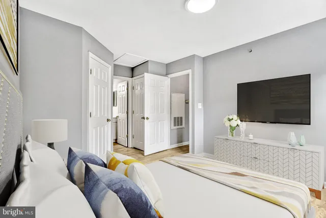 a bedroom with a bed and a flat screen tv