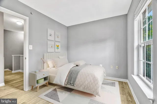 a bedroom with a bed and a large window