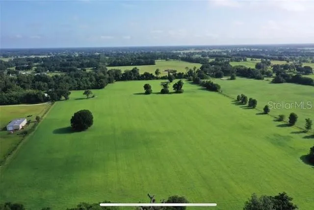 an aerial view of a house with yard