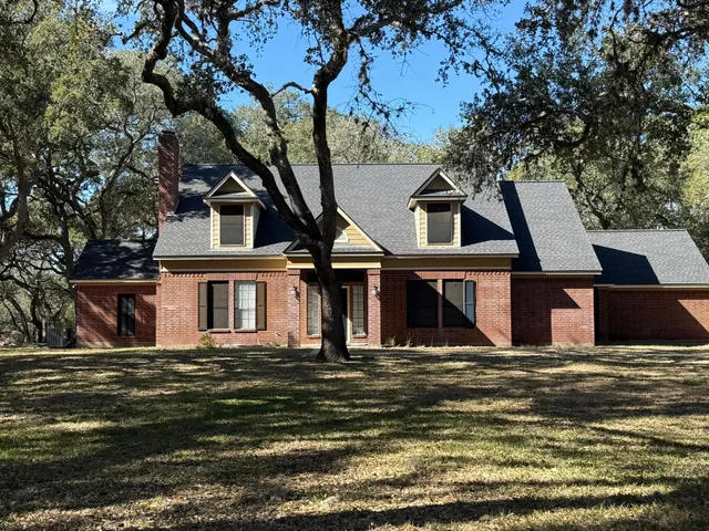 a view of a house with a large tree
