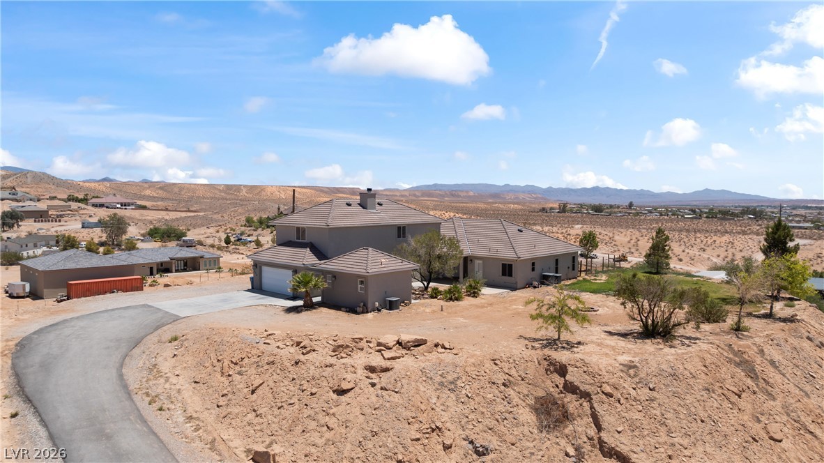 575 Gann Avenue Logandale, NV 89021 - Photo 71 of 75 An aerial perspective reveals a desert home with multiple structures, offering vast open views.