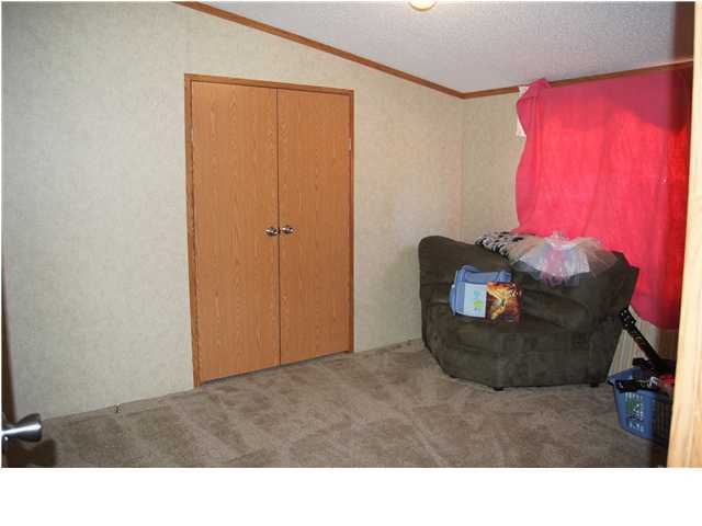 4493 Rainbird Rise Road Crestview, FL 32539 - Photo 11 of 27 a living room with furniture and a window