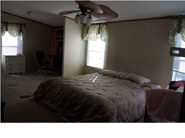 4493 Rainbird Rise Road Crestview, FL 32539 - Photo 16 of 27 a bedroom with a bed and a window