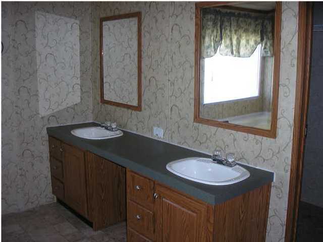 4493 Rainbird Rise Road Crestview, FL 32539 - Photo 20 of 27 a bathroom with a sink and a mirror