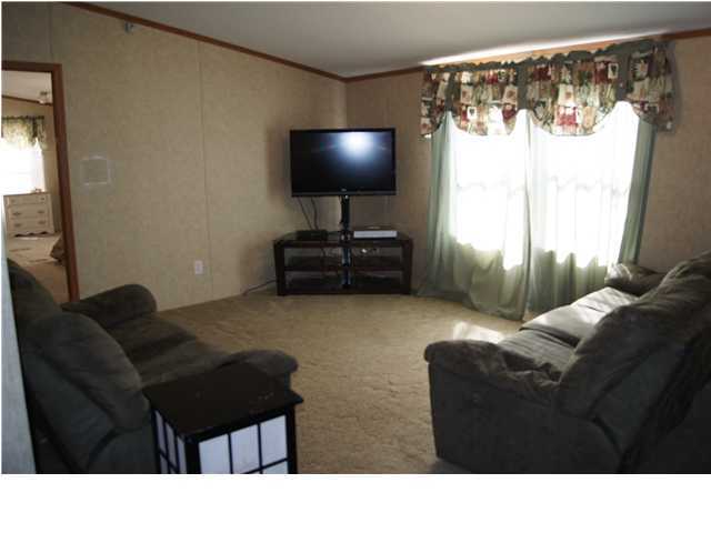 4493 Rainbird Rise Road Crestview, FL 32539 - Photo 3 of 27 a living room with furniture and a flat screen tv