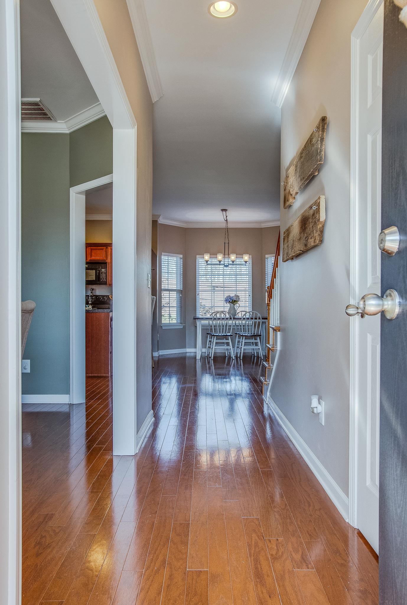 Entry foyer with formal dining room to the left and powder room to the right. Hardwoods throughout main level.