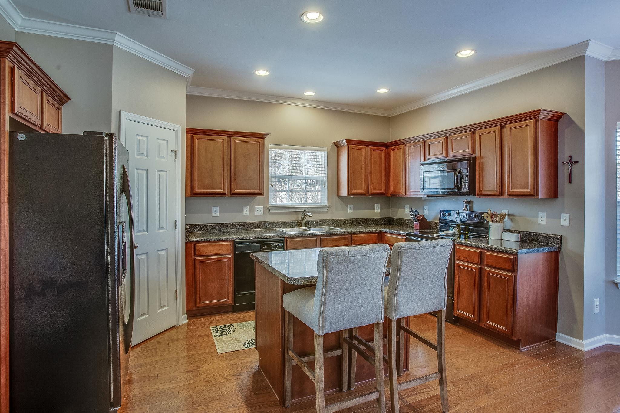 Bright kitchen with tons of cabinet and counter space, also walk-in pantry.