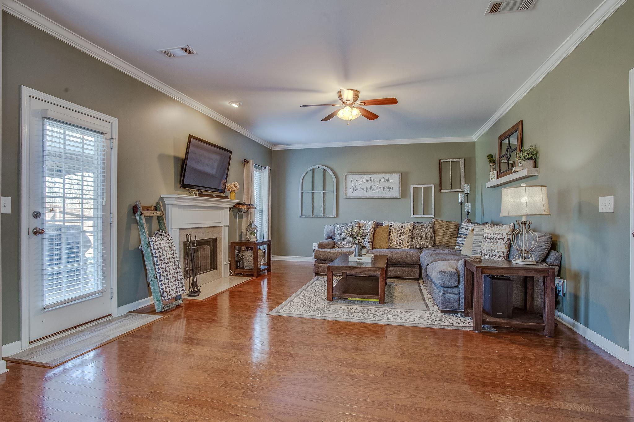 Large, open living room with wood burning fireplace.