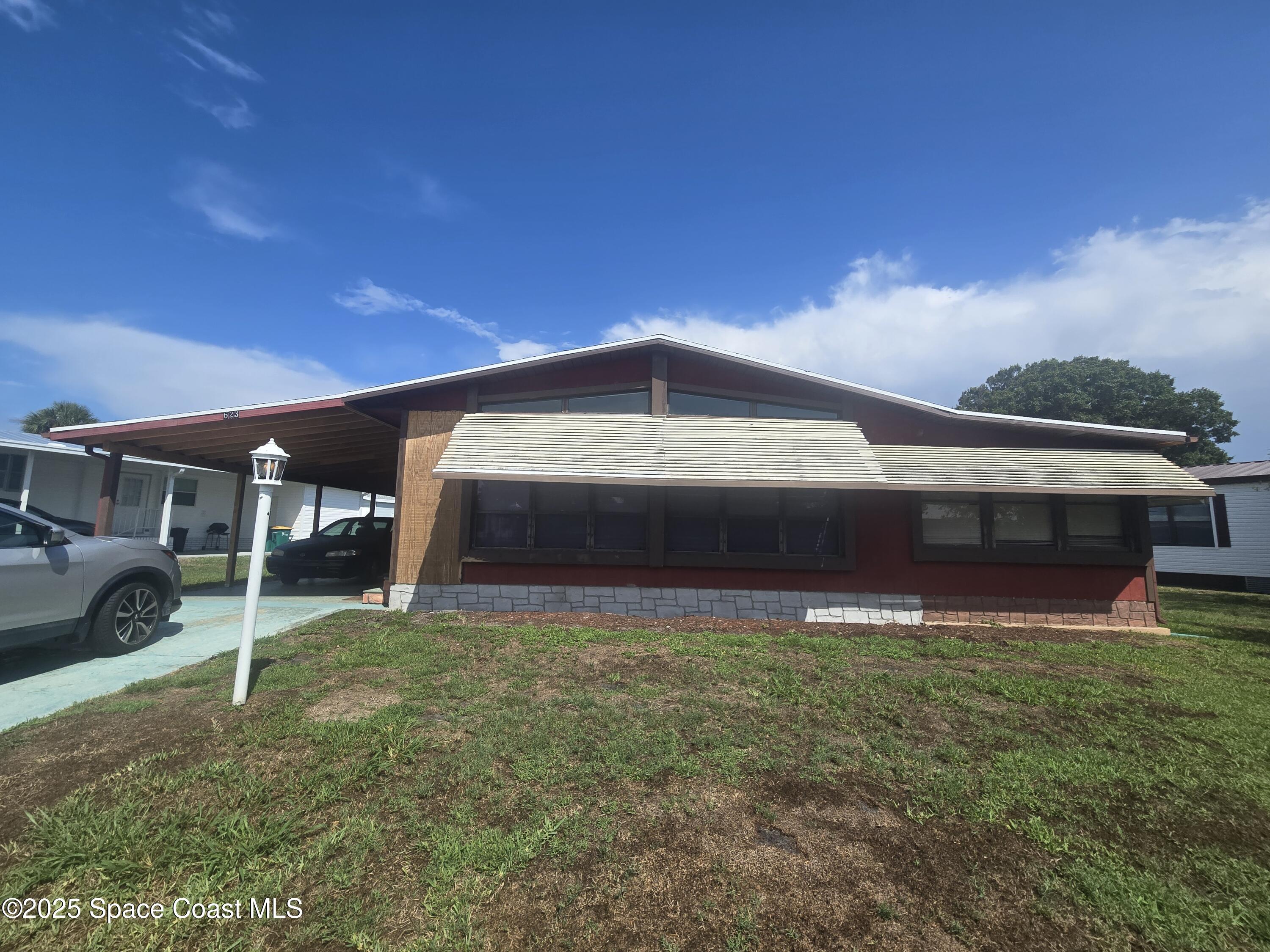 623 Marlin Circle Barefoot Bay, FL 32976 - Photo 1 of 20 a view of front of house with a yard