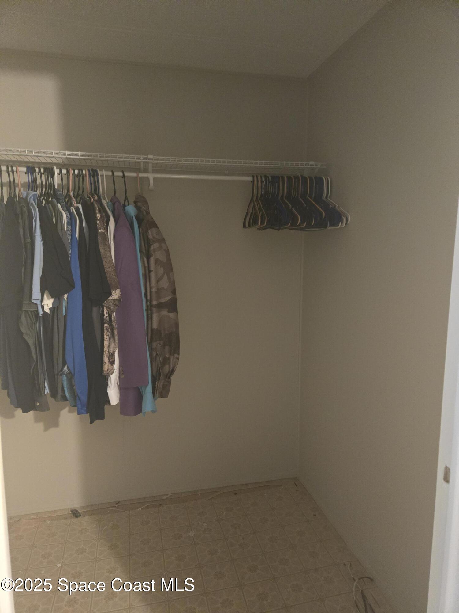 623 Marlin Circle Barefoot Bay, FL 32976 - Photo 12 of 20 a view of walk in closet with clothes and shoes