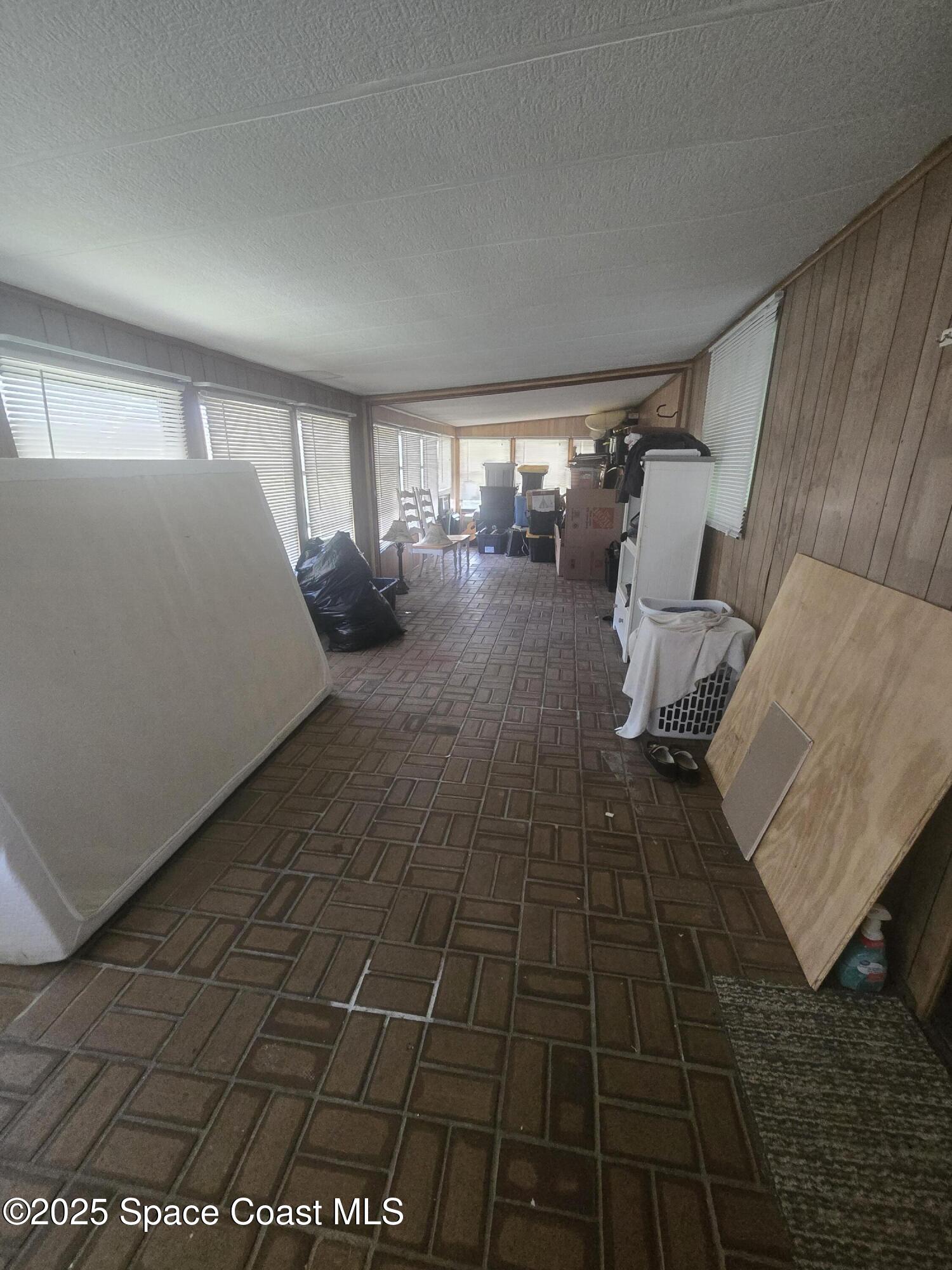 623 Marlin Circle Barefoot Bay, FL 32976 - Photo 17 of 20 a bed room with a bed and a window