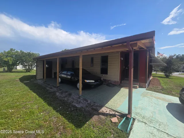 a view of a house with backyard porch and a garden