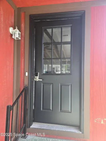 a view of a hallway with wooden floor and windows